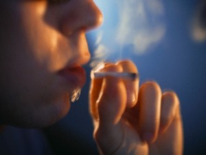 Young Man Smoking Marijuana Cigarette